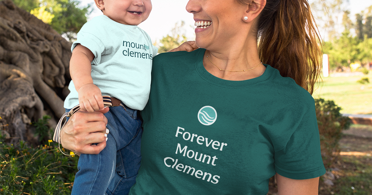 Mother and baby wearing branded Mount Clemens t-shirts.