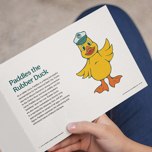 Image of brand book showing Mount Clemens mascot, Paddles the Rubber Duck.