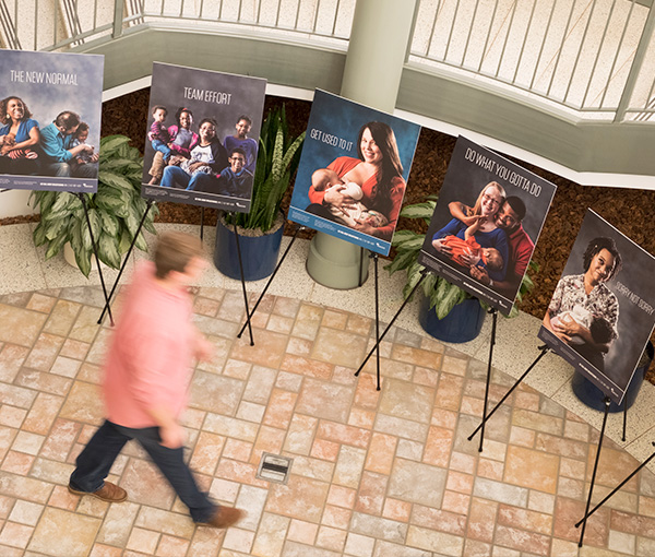 Person viewing campaign boards displayed on easels