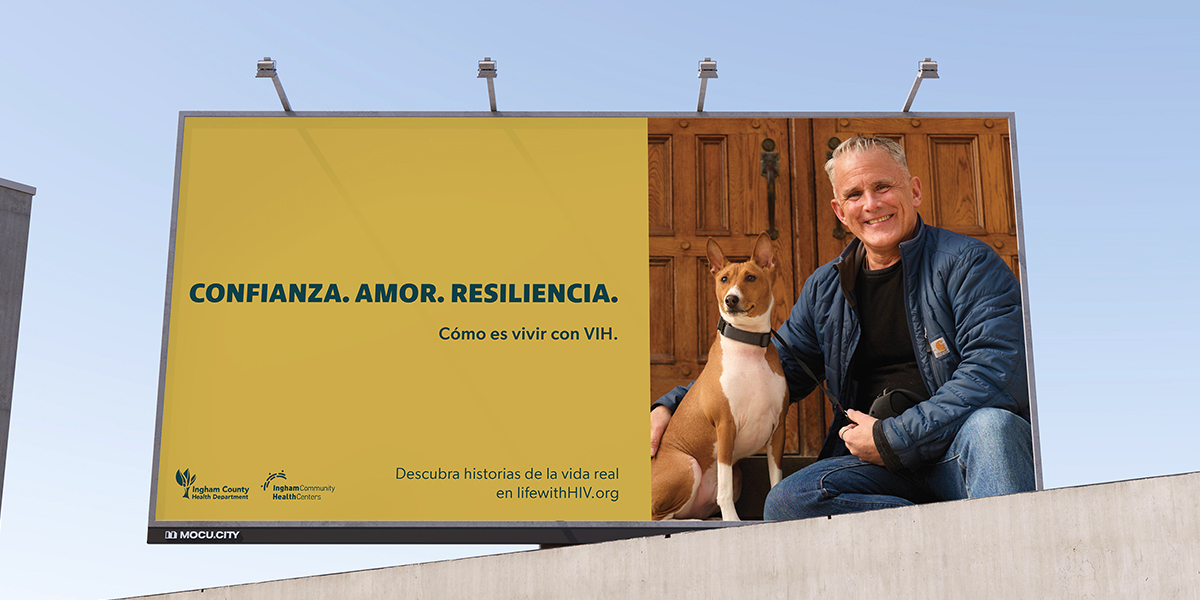 Billboard of person living with HIV with Spanish text