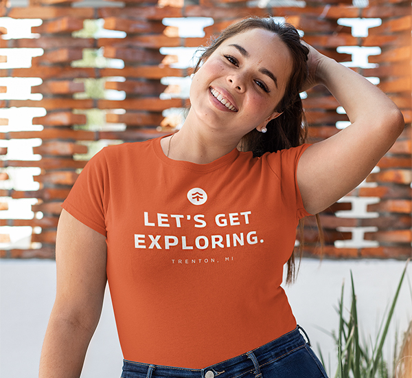 Girl in t-shirt that says "Let's Get Exploring"