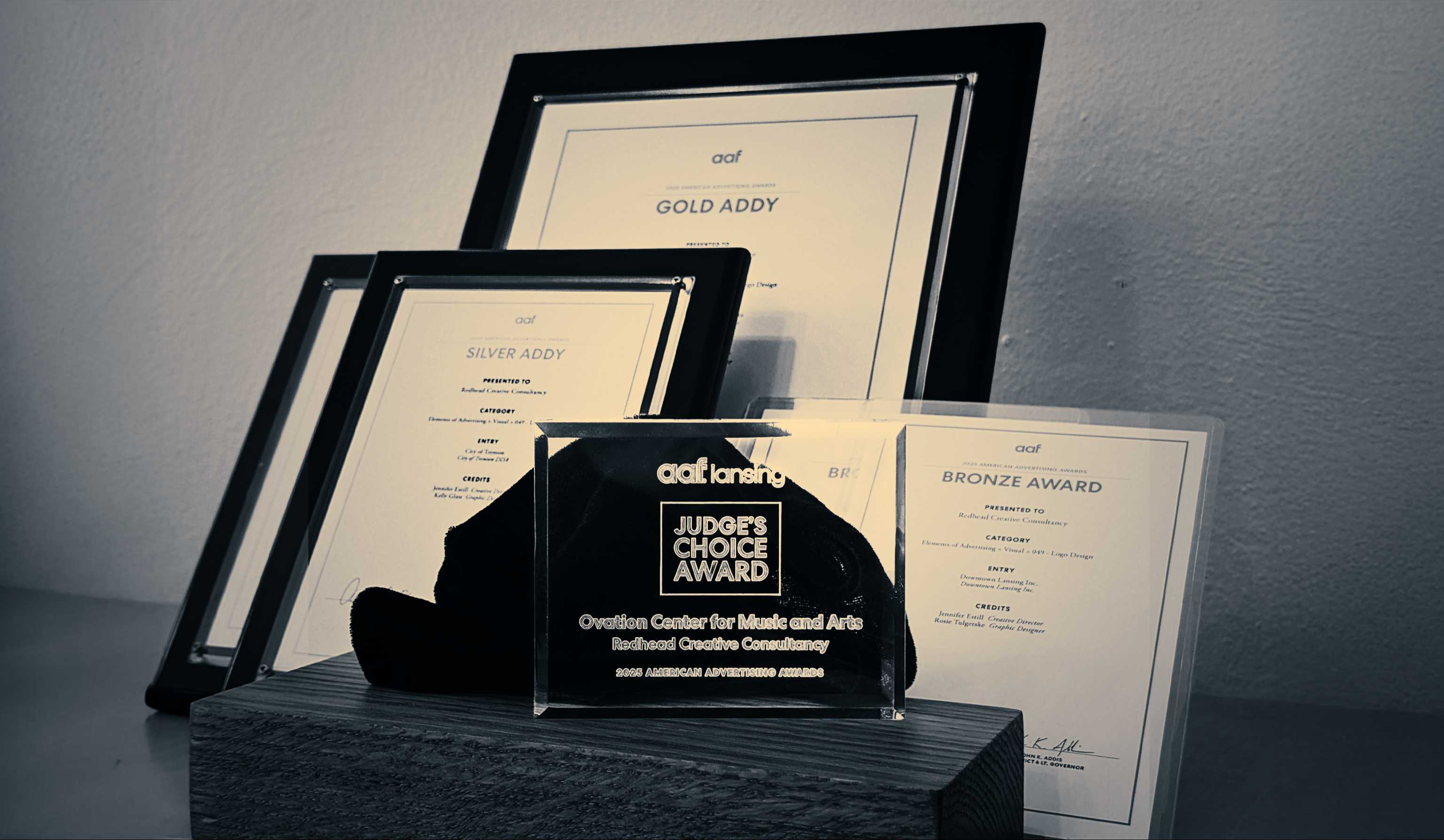 ADDY awards Redhead has earned appear in black and white, including a glass award that displays "Judge's Choice Award."