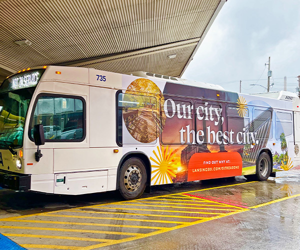 CATA bus wrapped with campaign art reading "Our city, the best city."