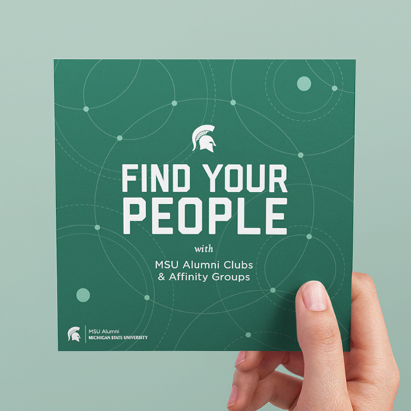 Hand holding square card reading, "Find your people" with MSU Alumni Club branding elements.