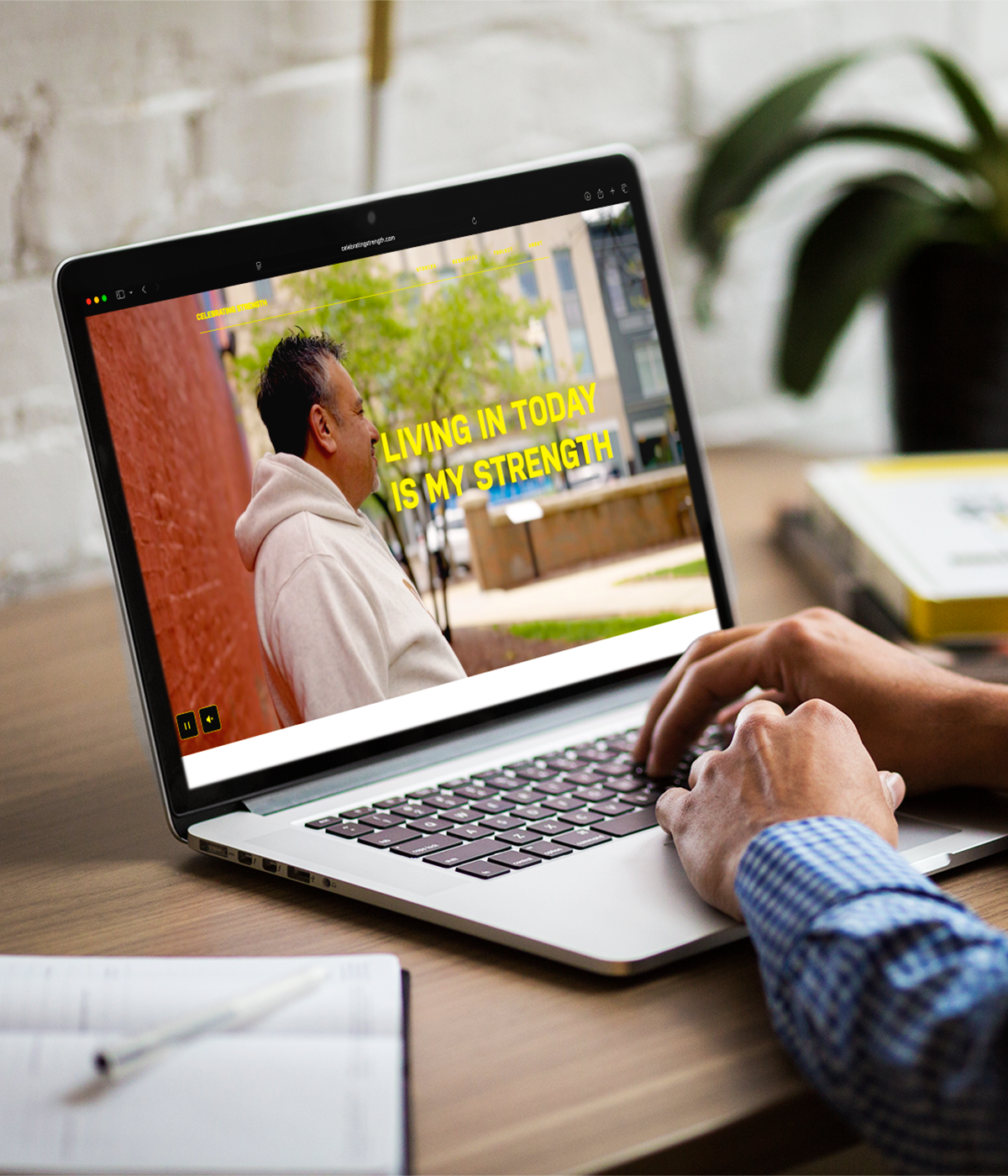 A website homepage video of a man on a laptop. 