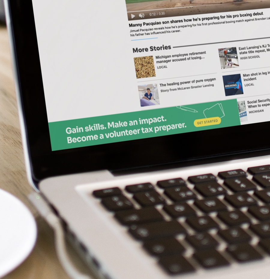 Small banner ad in corner of laptop screen encouraging volunteering to become a volunteer tax preparer