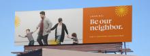 A billboard for Lansing 5:01 shows a picture of a family with the text: "Lansing: Be our neighbor."
